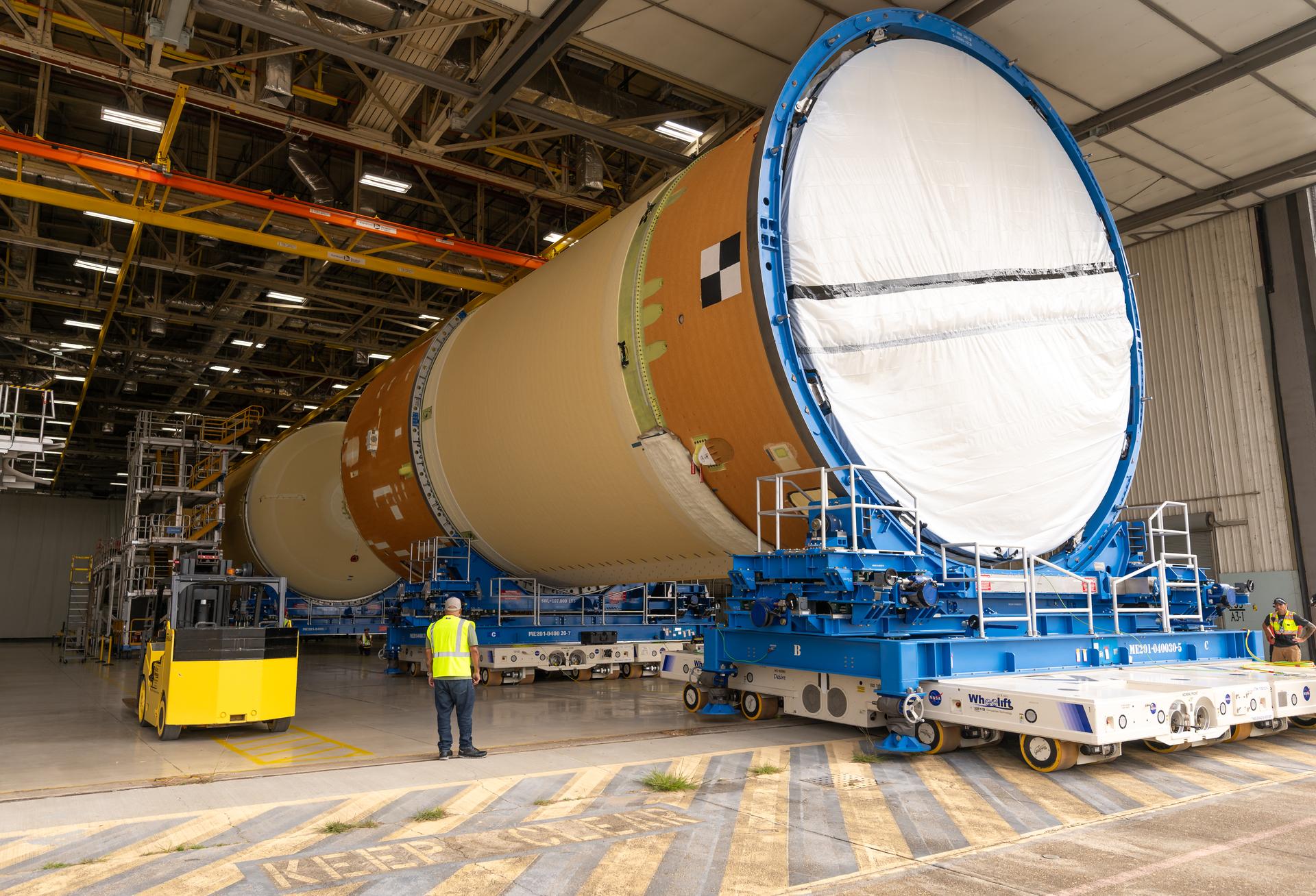 Move crews at NASA’s Michoud Assembly Facility in New Orleans, lift the forward-joined flight hardware for the agency’s SLS (Space Launch System) rocket out of a stacking cell in the vertical assembly building on Dec. 19, 2025. The forward join, which consists of the intertank, liquid oxygen tank, and forward skirt, will be used on the core stage slated for NASA’s Artemis III mission. Teams moved the flight hardware from the cell and set it atop self-propelled mobile transporters. The article was brought to the factory’s final assembly area on Dec. 27, 2025 where it will be mated to the core stage’s previously joined liquid hydrogen tank and undergo further integration.    The core stage, along with its four RS-25 engines, produce more than two million pounds of thrust to help launch NASA’s Orion spacecraft, astronauts, and supplies beyond Earth’s orbit and to the lunar surface for Artemis.